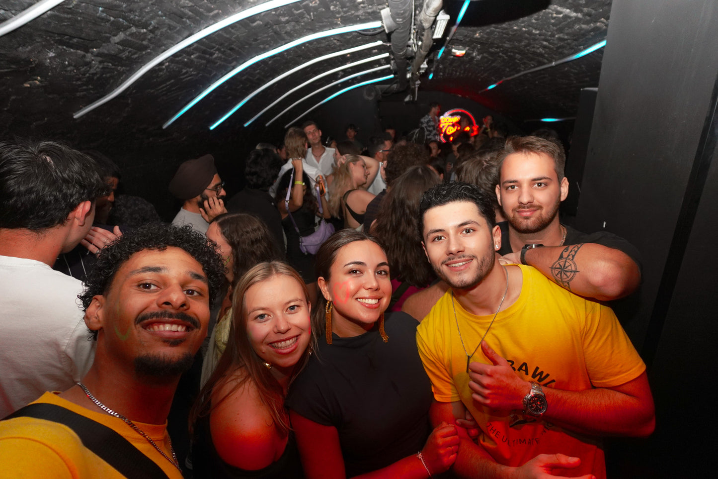 Group of friends partying during a bar tour in Nice, having drinks and playing games.