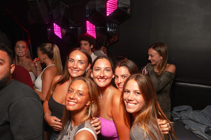 Happy group smiling at the camera during a Beer&Dash pub crawl in the old town of Nice.